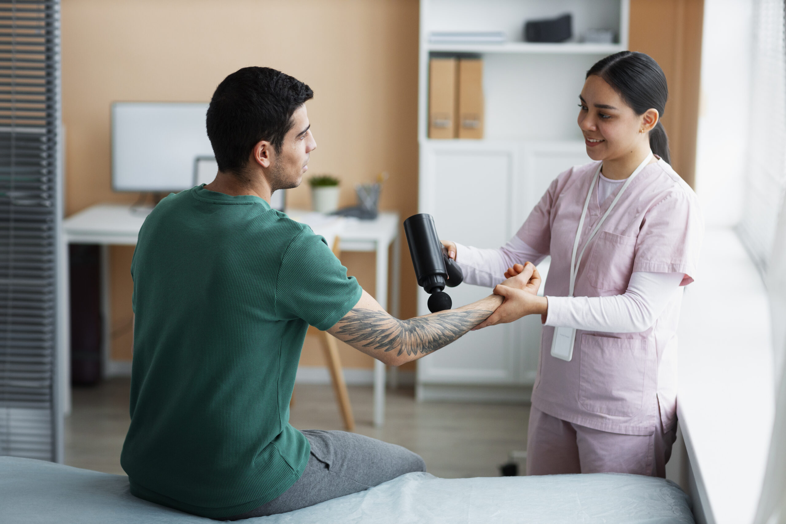 doctor helping patient rehabilitation scaled